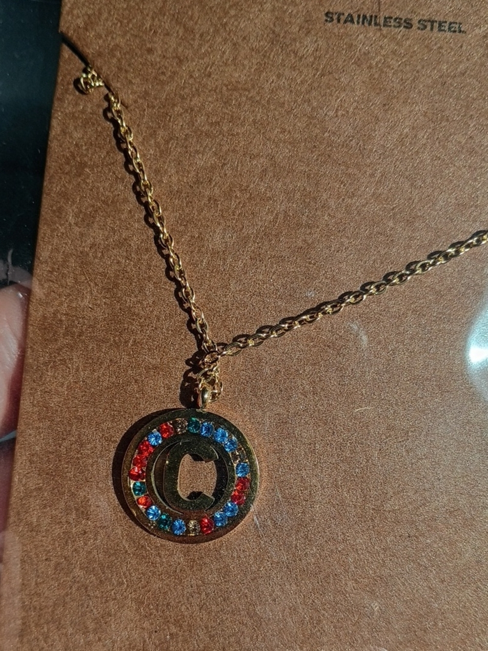 Stainless Steel Gold-Tone Circle Pendant Necklace with Red & Blue Crystals